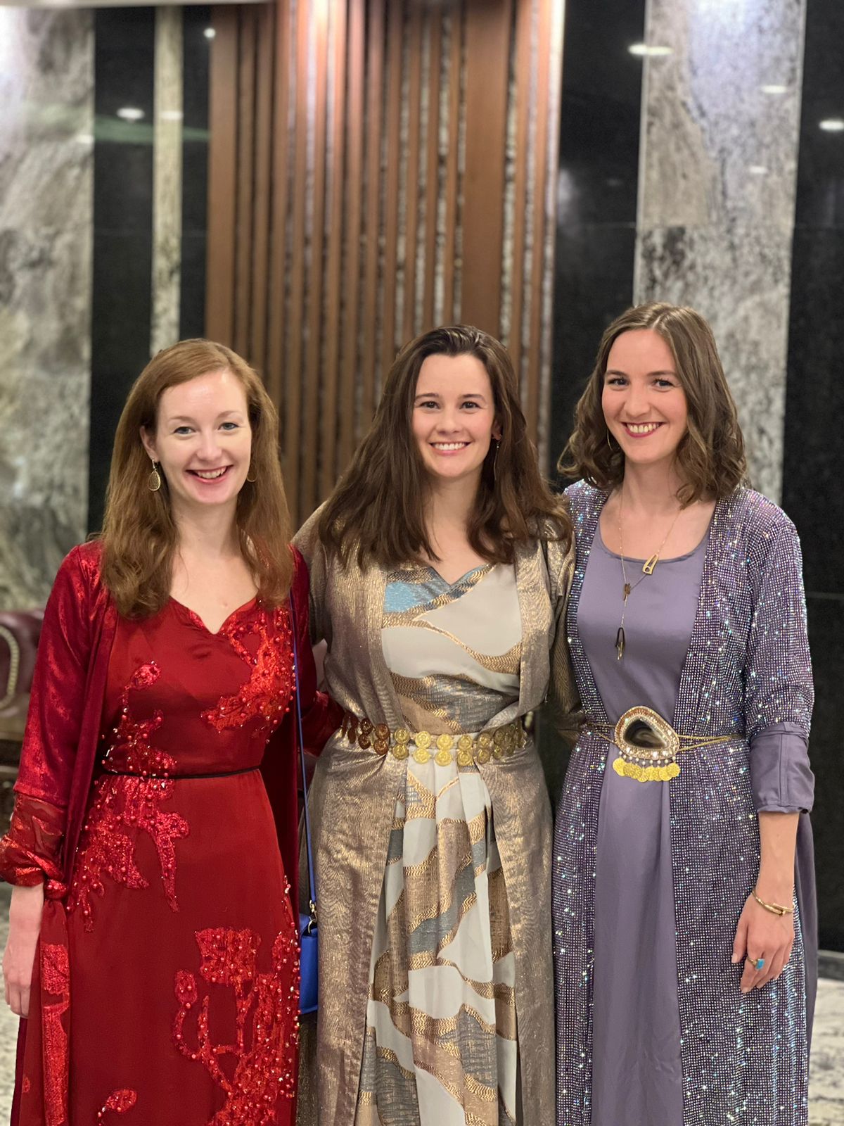 Three friends in traditional Kurdish dresses