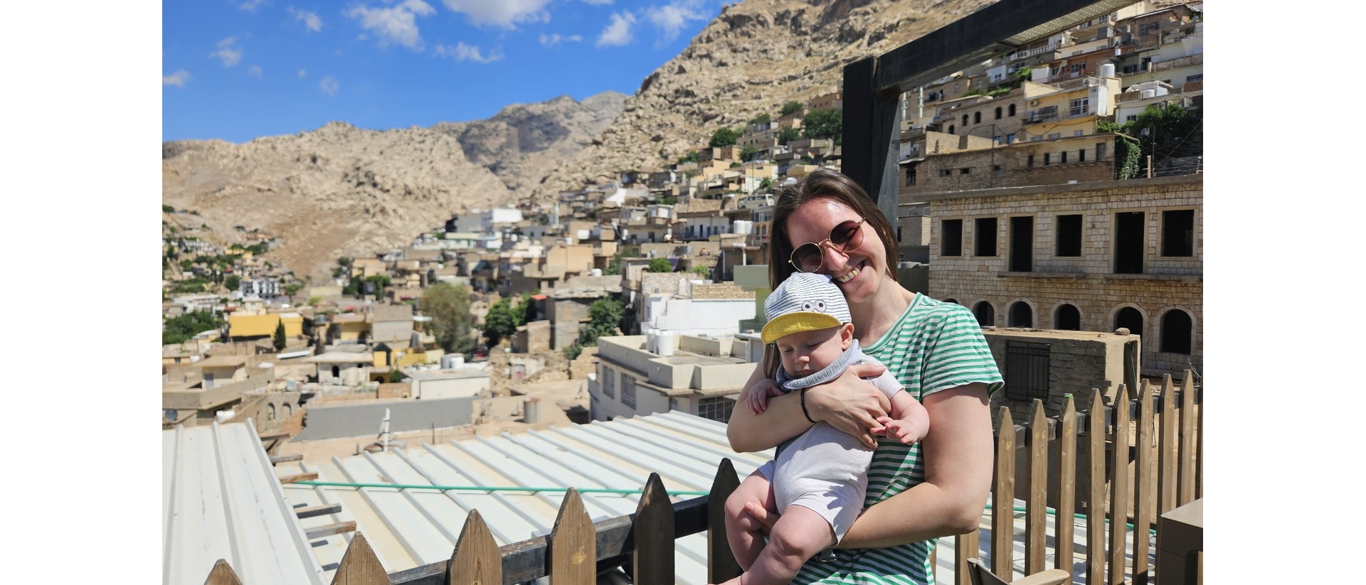 Mom holding baby with mountain view