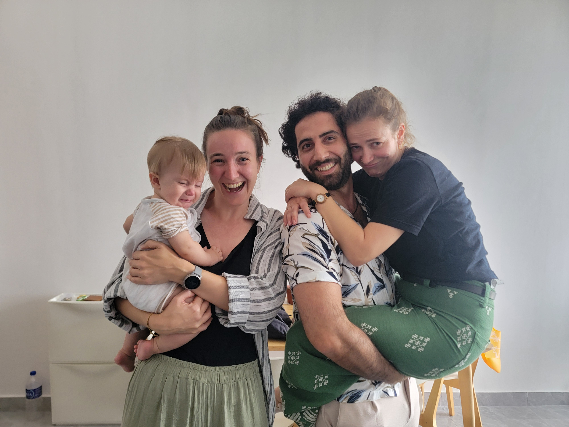 Friends laughing together with baby