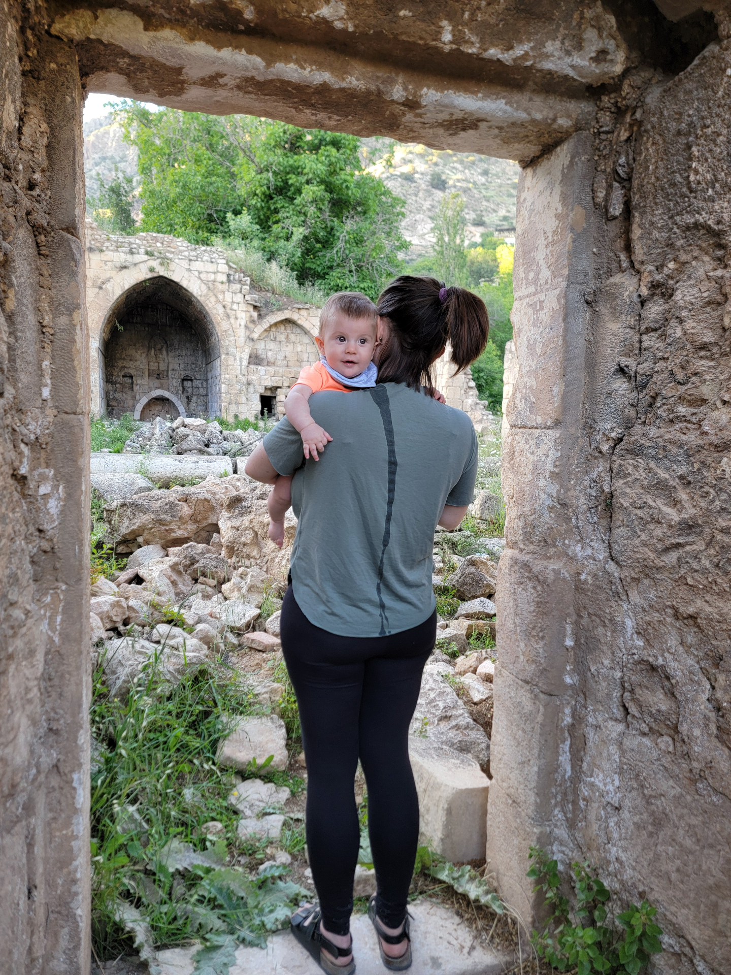 Mother and baby exploring ancient ruins