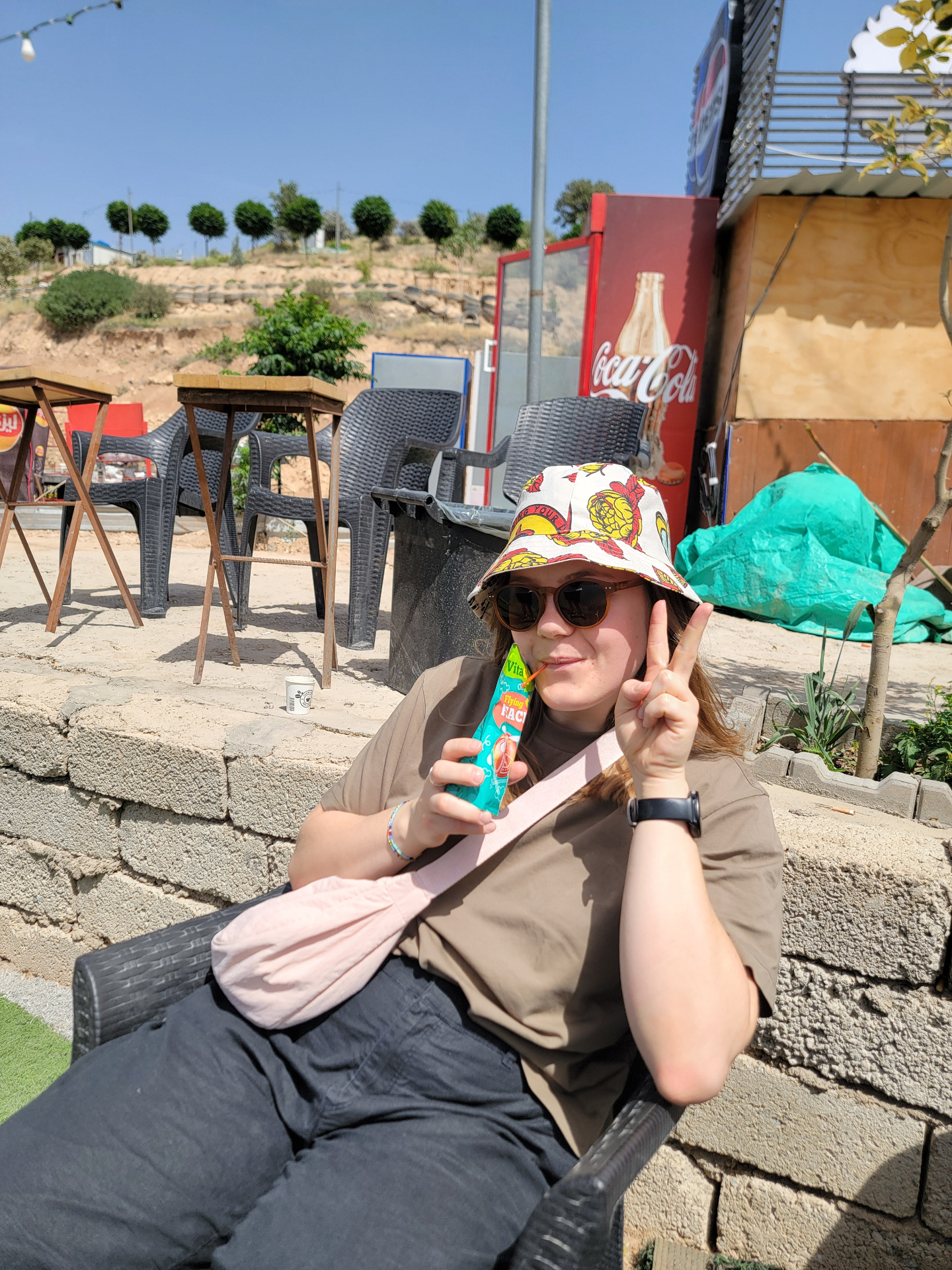 Peace sign with a snack outdoors